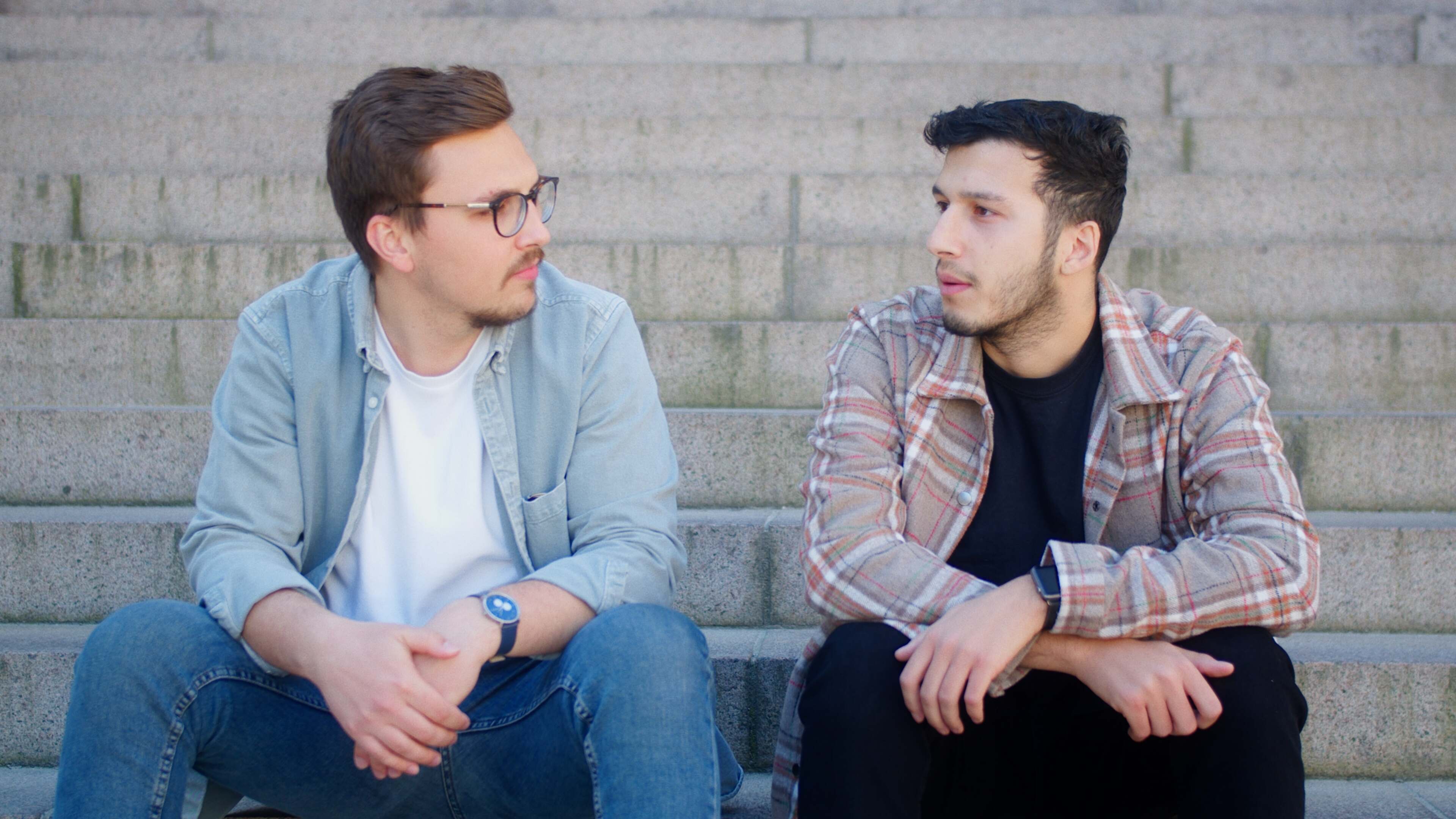 Two men sitting on steps