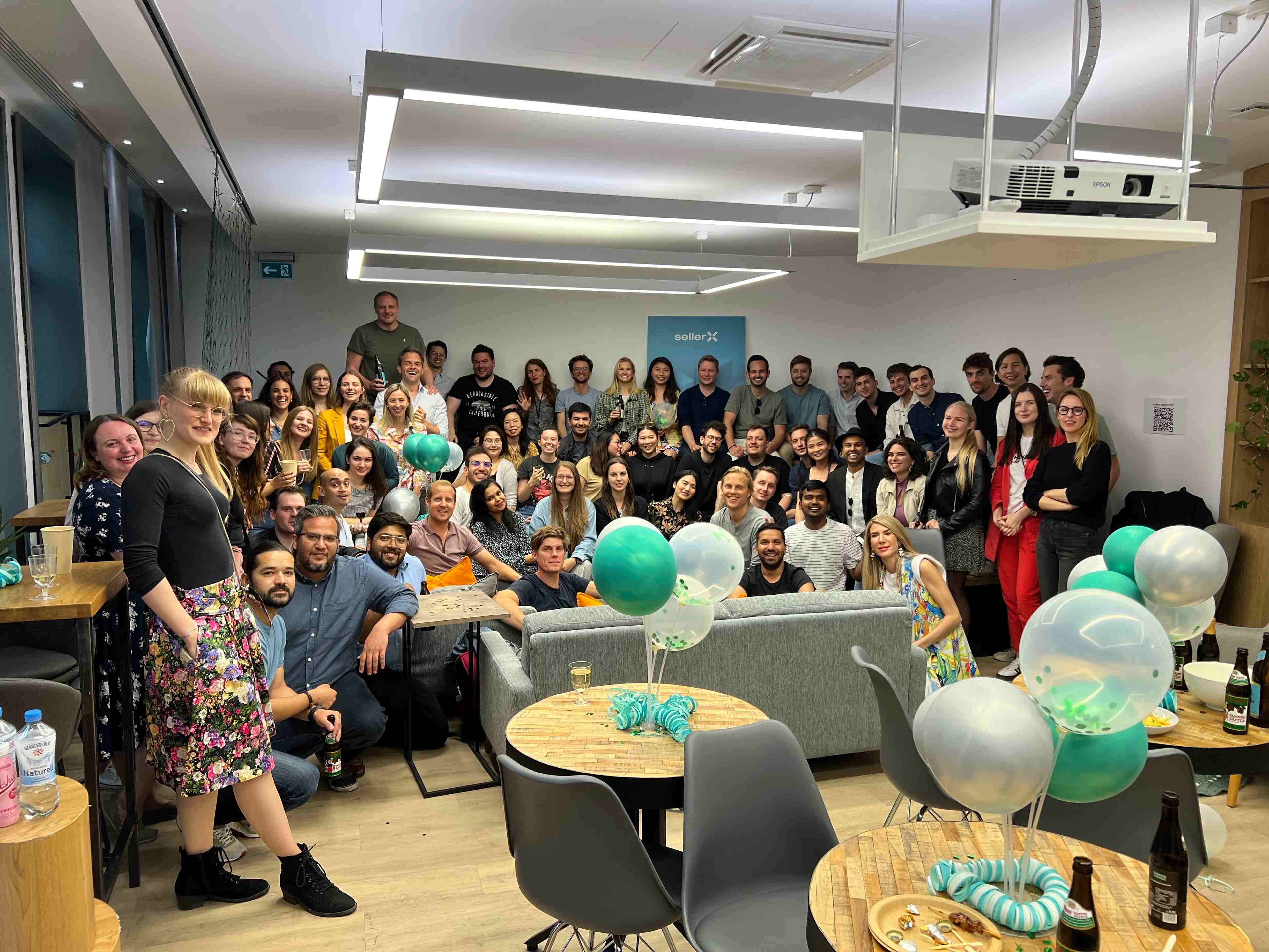Happy large team of people posing for the camera in an office