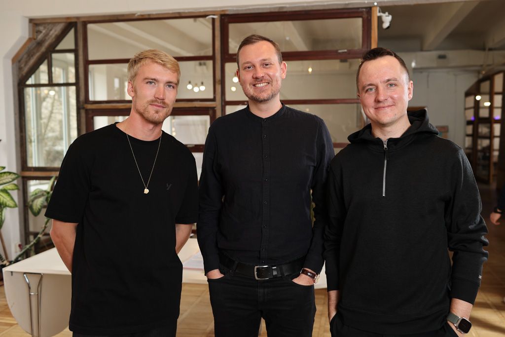 Photo of three men in an office space