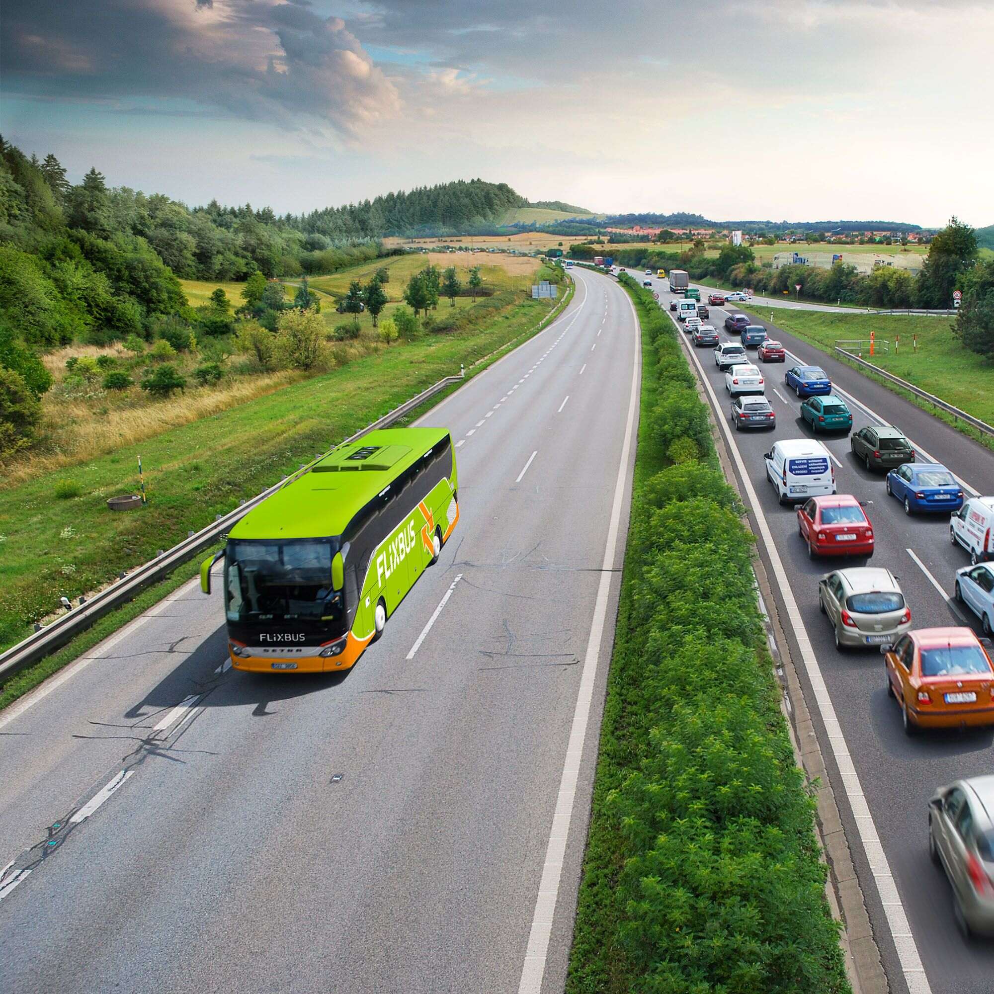 Green Flixbus bus on an empty parking lot in the sunset